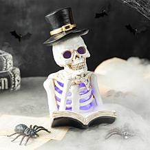 Glitzhome 10.25in. H Halloween Lighted Resin Skull Book Table Decor