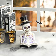 Glitzhome 10.25in. H Halloween Lighted Resin Skull Book Table Decor